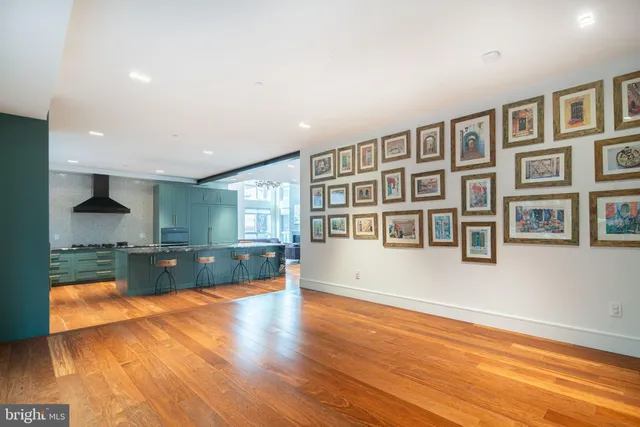 a large kitchen with stainless steel appliances granite countertop a stove a sink and a refrigerator