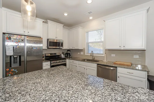 a kitchen with a sink stove and refrigerator