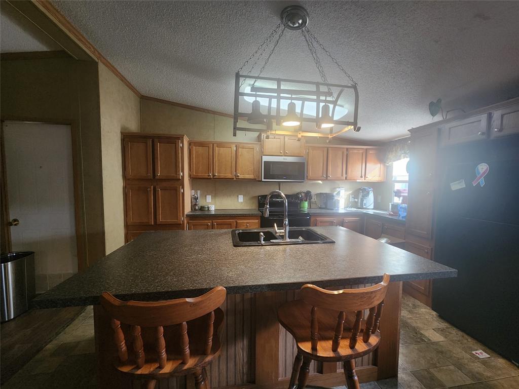 11308 County Road 313 East Tyler, TX 75708 - Photo 5 of 14 a kitchen with a dining table chairs and refrigerator