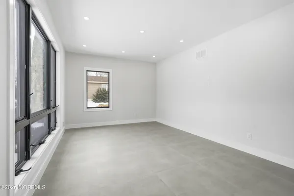 a large kitchen with a stove a sink and a refrigerator