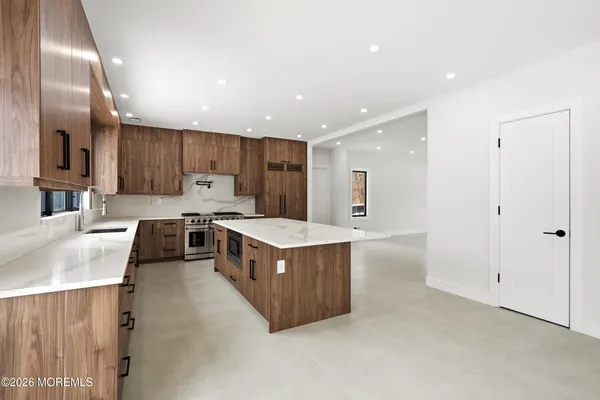 a kitchen with a sink stove and cabinets