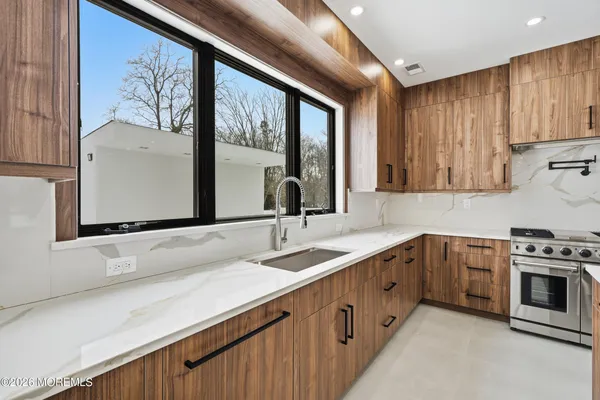 a kitchen with a sink stove and cabinets