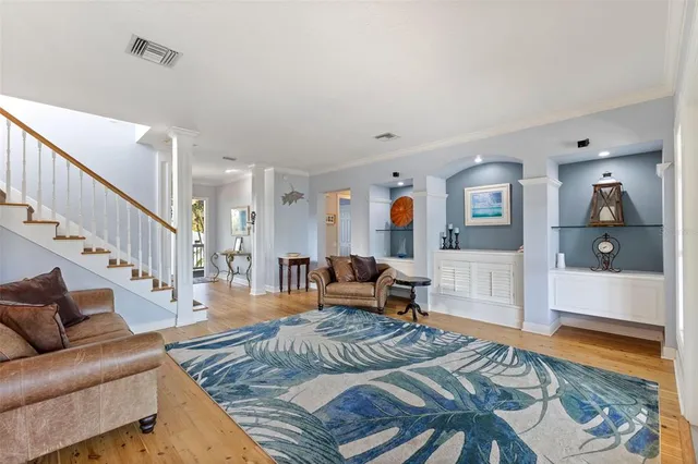 a kitchen with stainless steel appliances kitchen island granite countertop a table chairs and a refrigerator