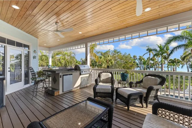 a view of balcony with wooden floor and seating space
