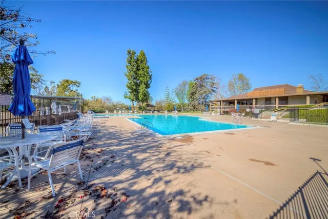 a view of outdoor space with swimming pool and seating