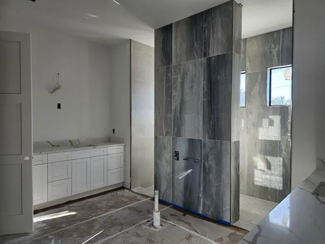 a bathroom with a double vanity sink and mirror