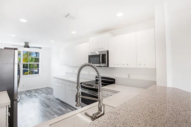 a white toilet sitting next to a white wall