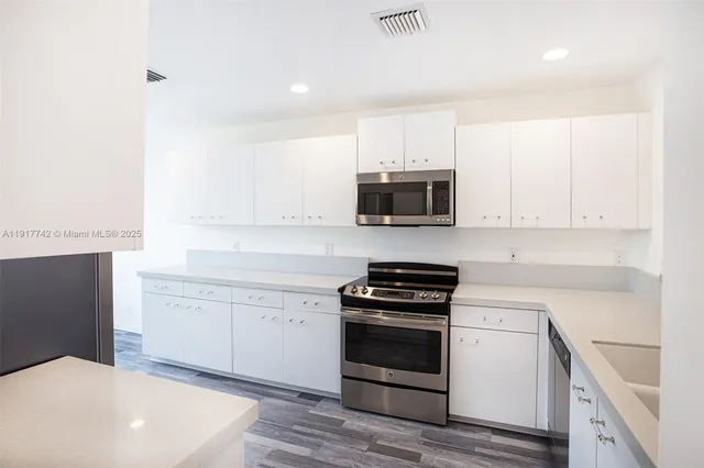 a view of a hallway with white walls