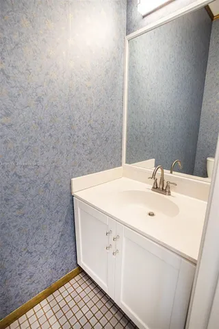 an empty room with wooden floor and a ceiling fan