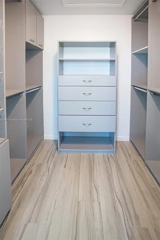 a view of an empty room with a floor to ceiling window