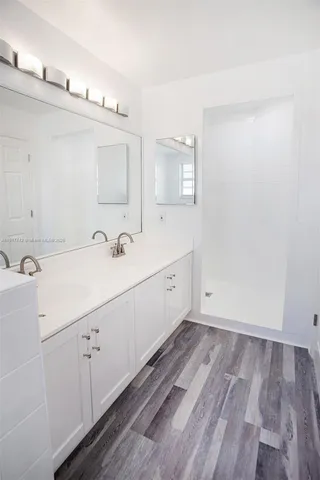 a view of a room with wooden floor