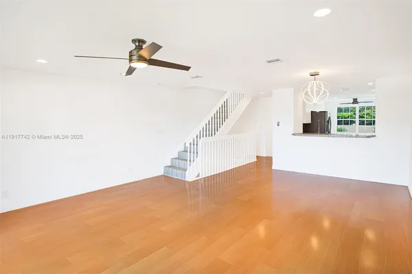 a kitchen with a refrigerator and a sink