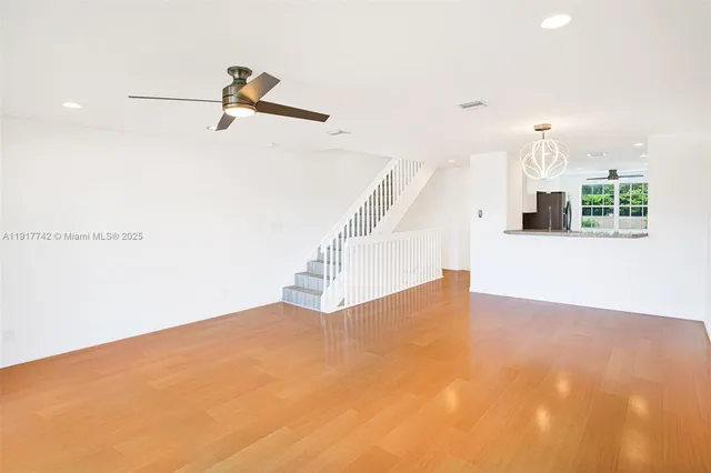 a kitchen with a refrigerator and a sink