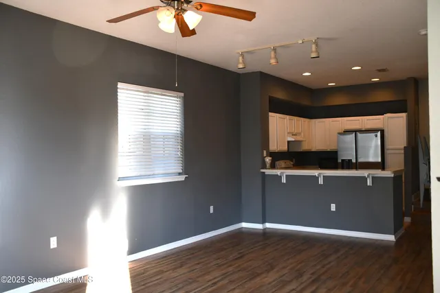 a workspace with wooden floor and windows