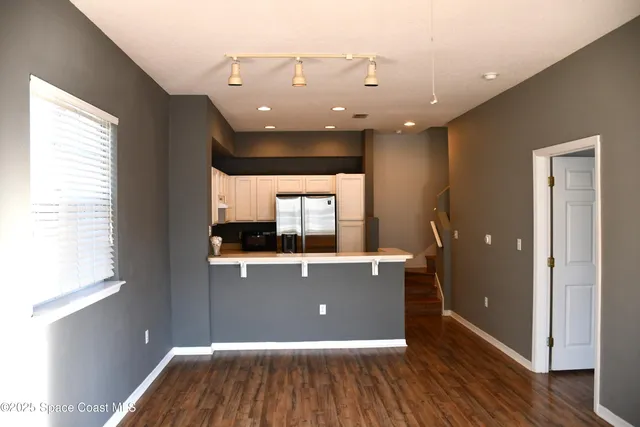 a view of room with wooden floor and window