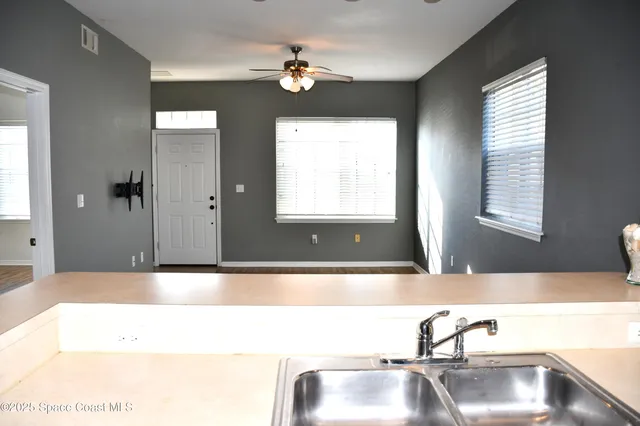 a bathroom with a tub a sink and a window