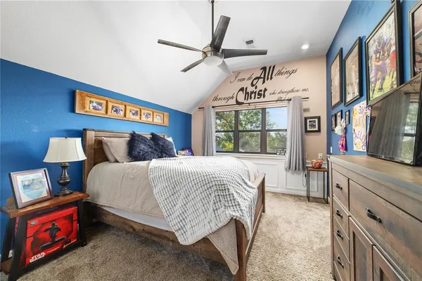 a bedroom with a bed dresser and a window