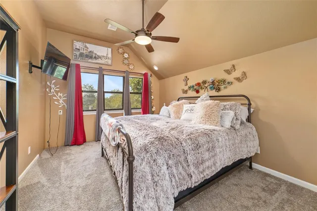 a bedroom with a large bed and a chandelier