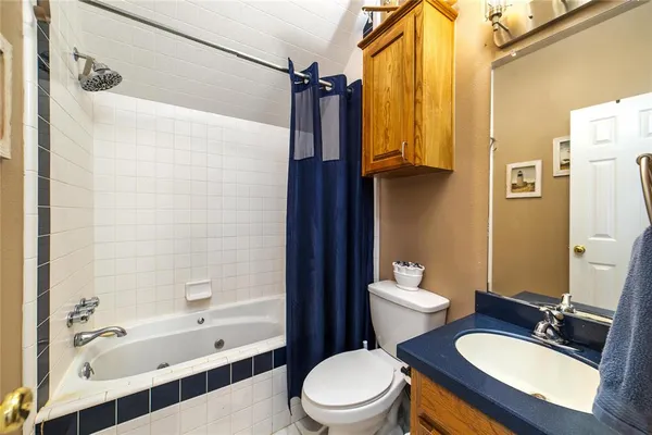 a bathroom with a granite countertop sink toilet a shower and bathtub