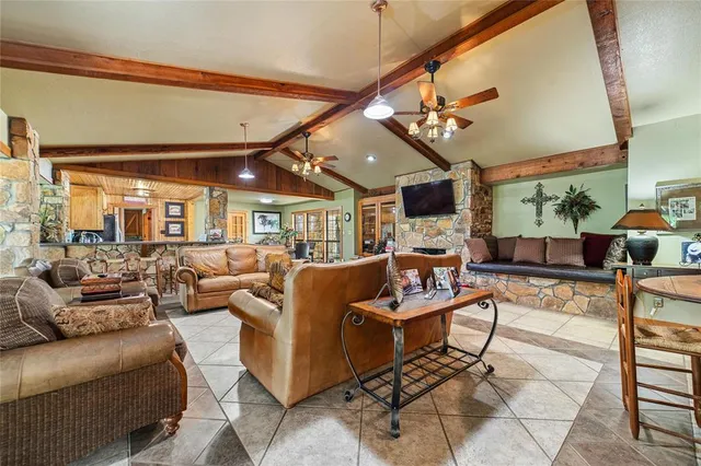 a living room with lots of furniture and a large window