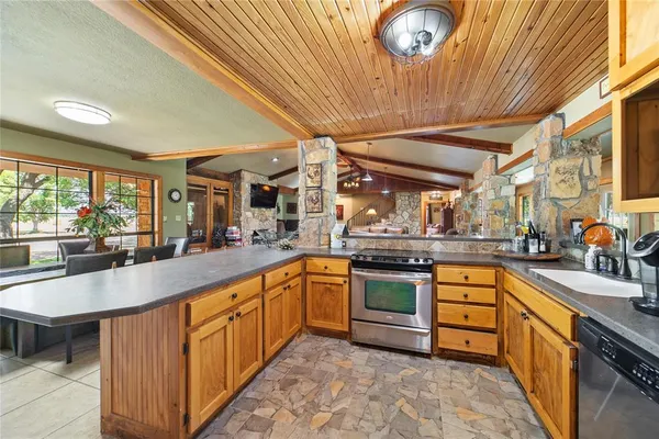 a dining room with furniture large windows and wooden floor