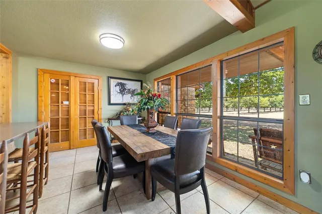a spacious bedroom with a bed a chandelier and glass door