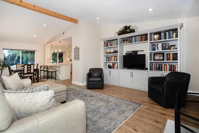 a living room with furniture workspace and a flat screen tv