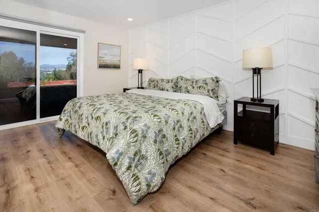 a bedroom with a bed and a lamp