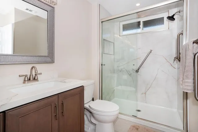 a bathroom with a sink toilet and shower