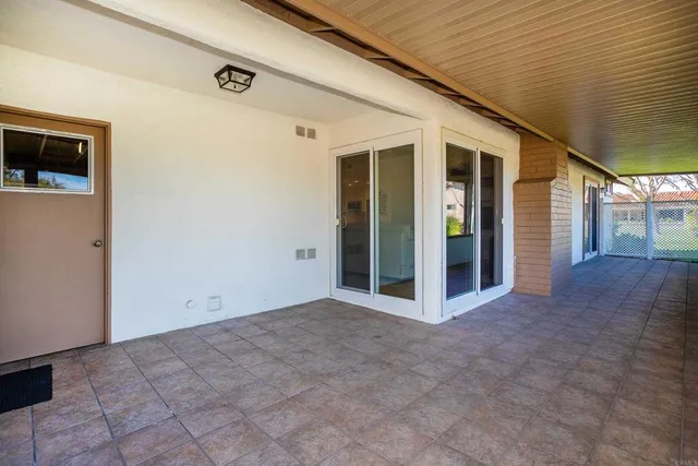 a view of a hallway with wooden floor and entryway