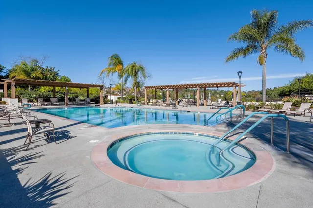 a view of a swimming pool with outdoor seating