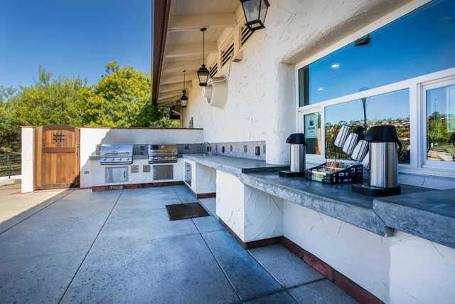 a large kitchen with stainless steel appliances granite countertop a sink and cabinets
