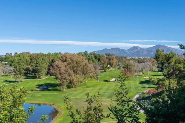 a view of a lush green hillside and an houses
