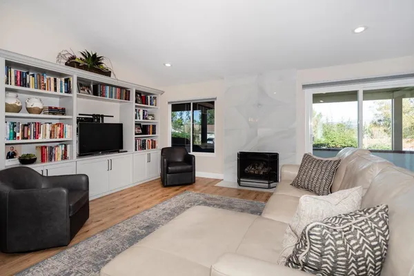 a living room with furniture and a fireplace
