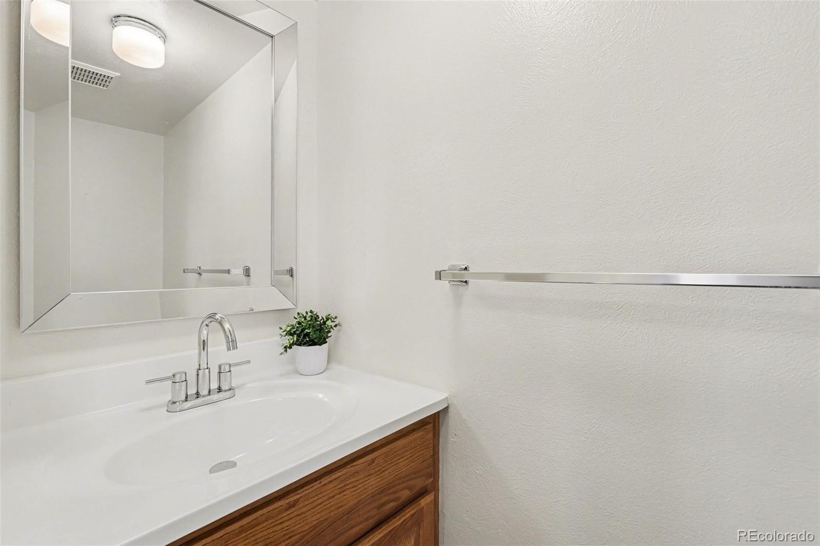 15922 East Rice Place, Unit B Aurora, CO 80015 - Photo 12 of 30 a bathroom with a sink and a mirror