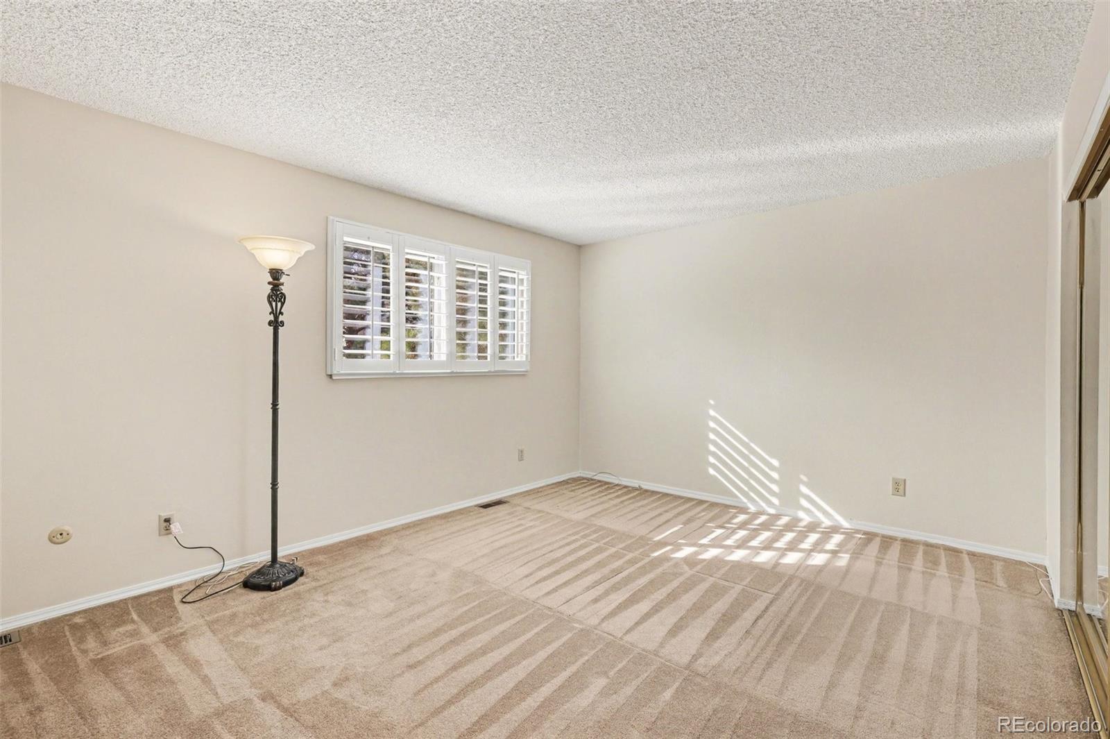 15922 East Rice Place, Unit B Aurora, CO 80015 - Photo 14 of 30 an empty room with windows
