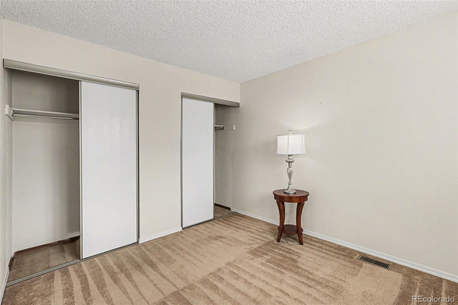 15922 East Rice Place, Unit B Aurora, CO 80015 - Photo 16 of 30 a view of a livingroom with wooden floor and a cabinet