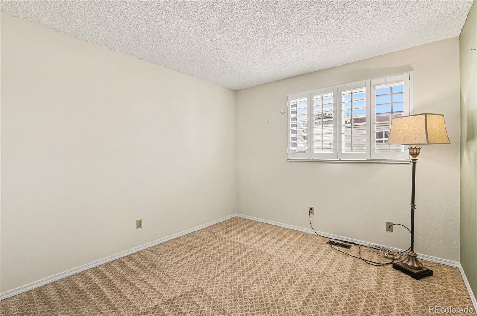 15922 East Rice Place, Unit B Aurora, CO 80015 - Photo 17 of 30 a room with a bed and a window