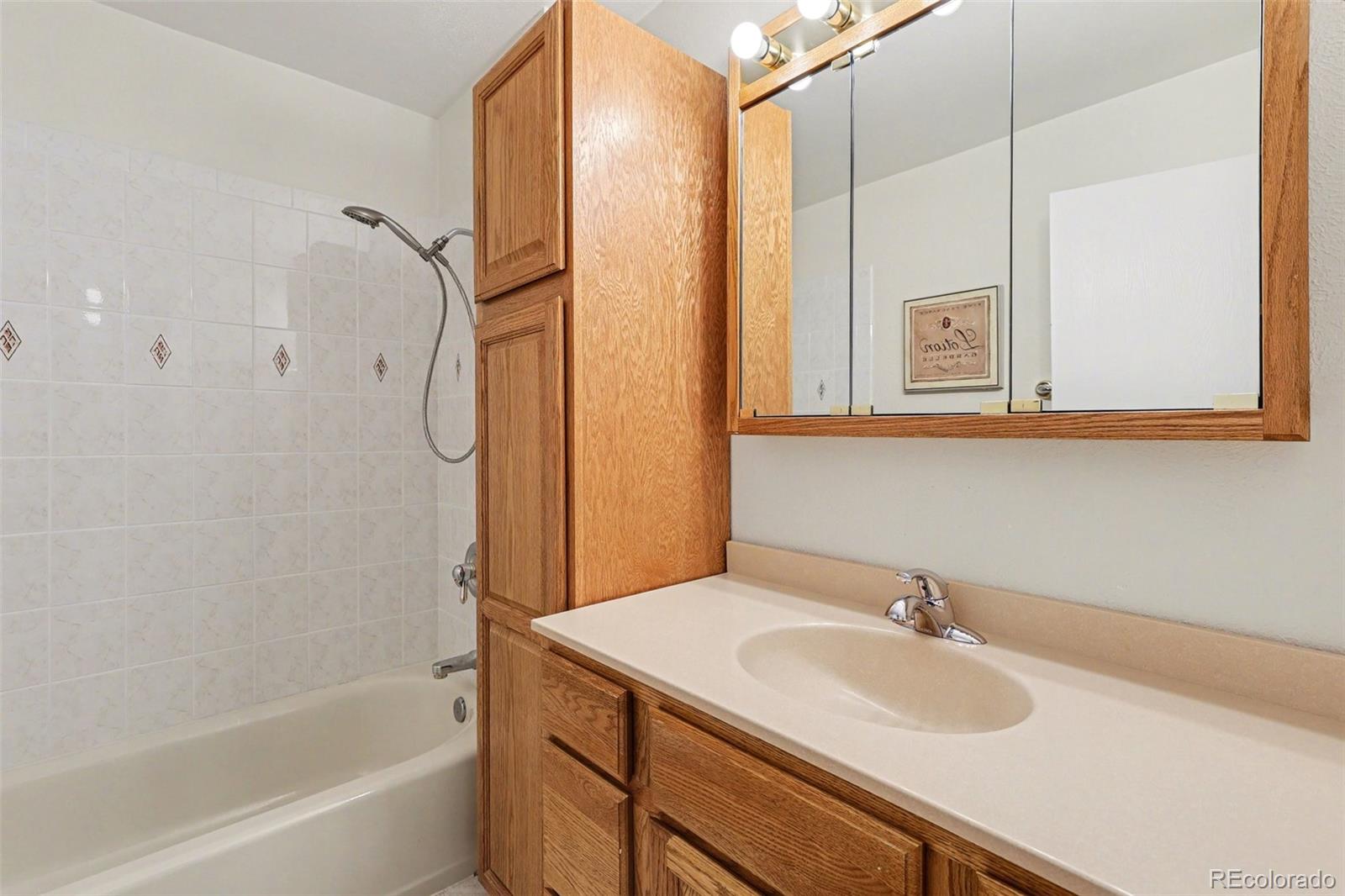15922 East Rice Place, Unit B Aurora, CO 80015 - Photo 19 of 30 a bathroom with a sink and a mirror