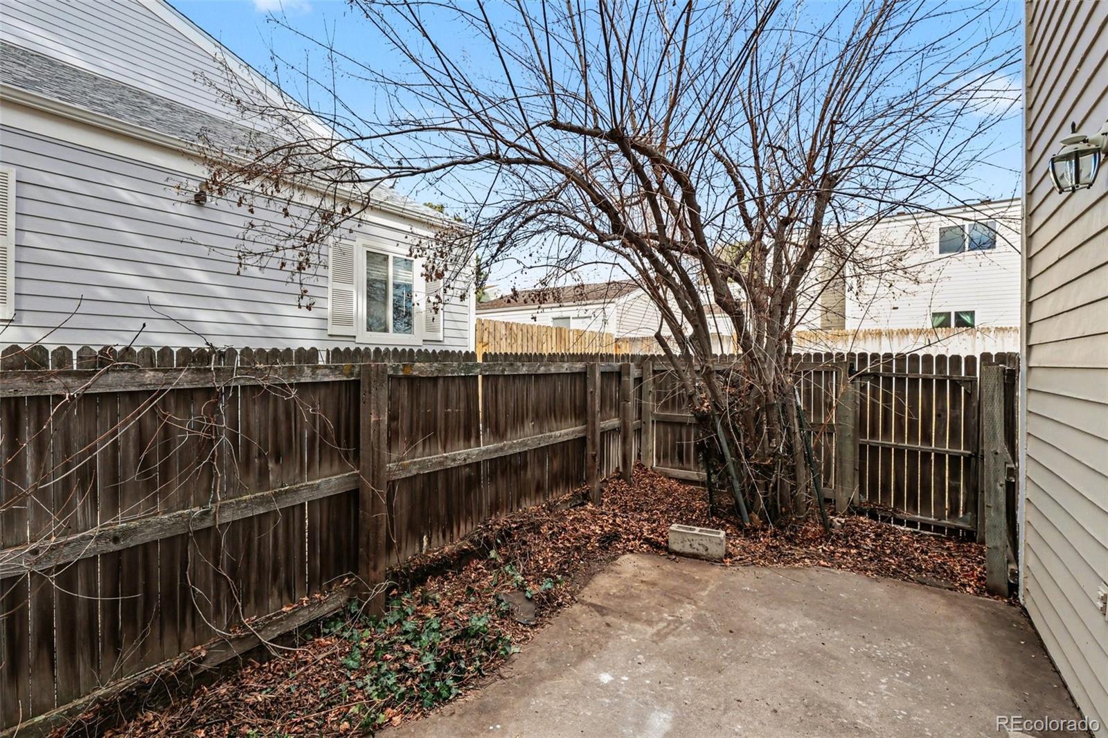 15922 East Rice Place, Unit B Aurora, CO 80015 - Photo 20 of 30 a view of a yard with wooden fence