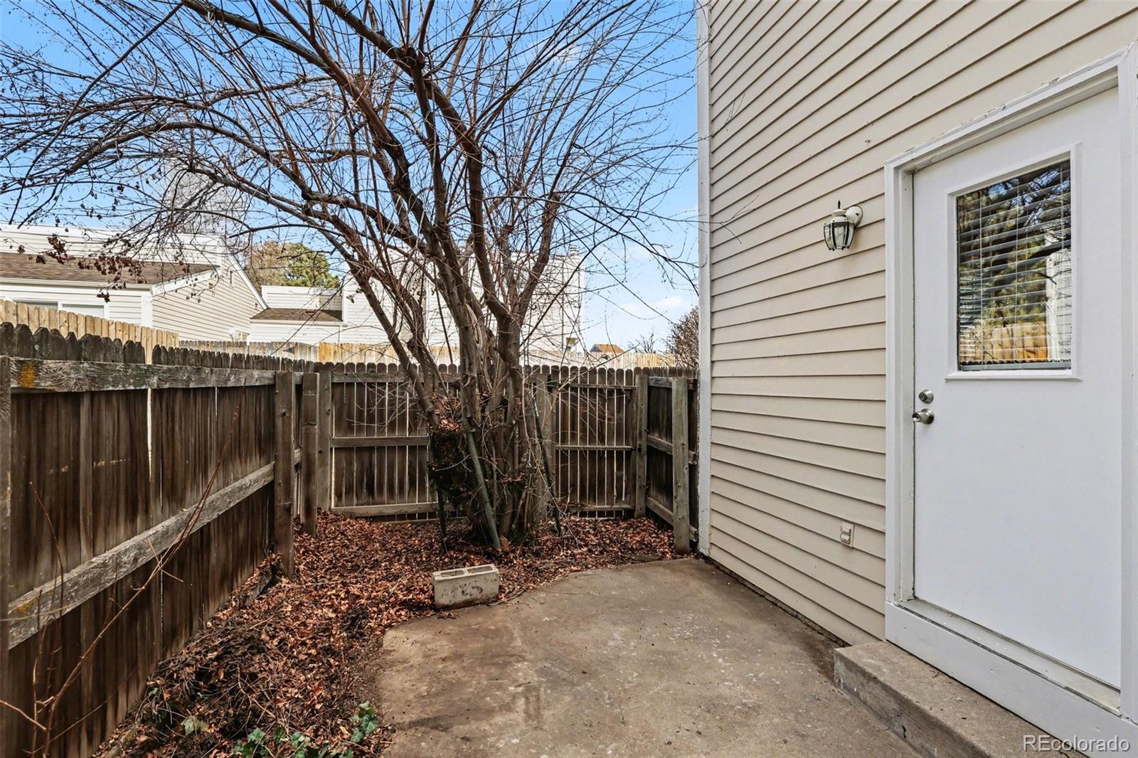 15922 East Rice Place, Unit B Aurora, CO 80015 - Photo 21 of 30 a view of house with backyard and trees