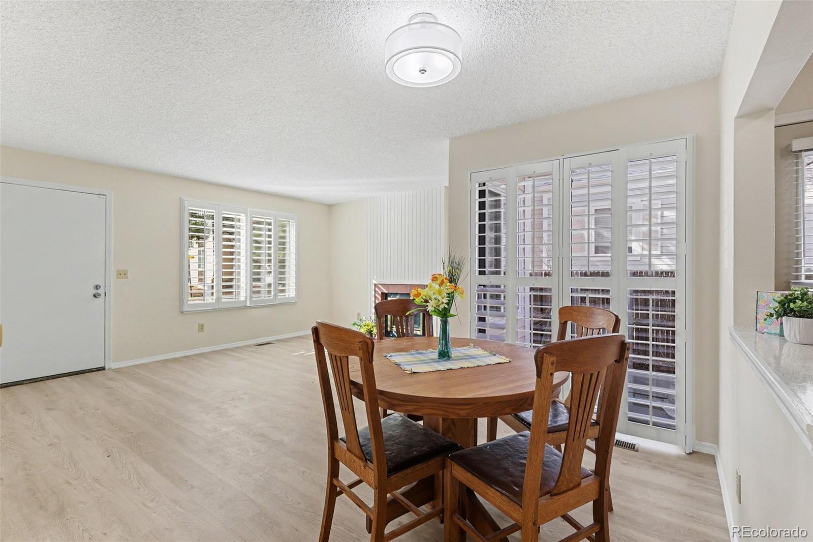 15922 East Rice Place, Unit B Aurora, CO 80015 - Photo 7 of 30 a view of a dining room with furniture window and wooden floor