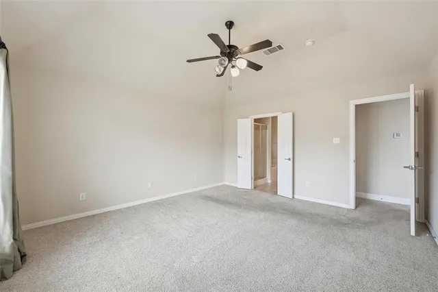 a view of a livingroom with a ceiling fan and window
