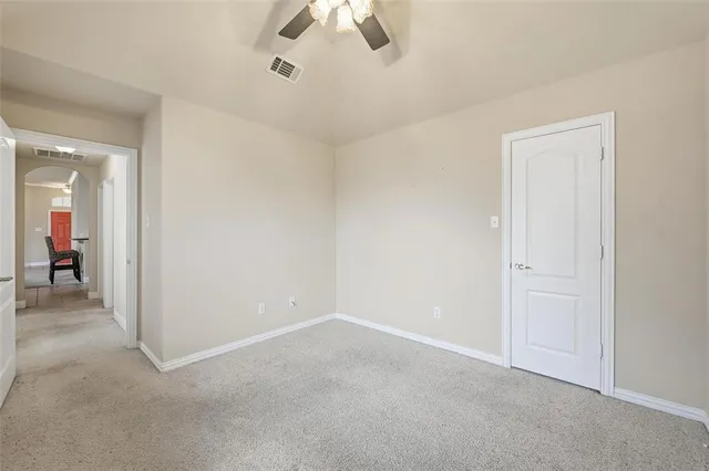 a view of a livingroom with a ceiling fan and window