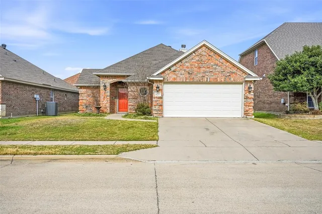 a view of a house with a yard and garage