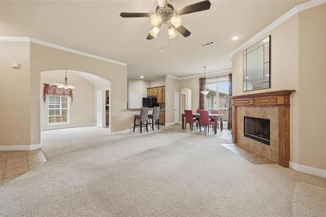 a living room with furniture a fireplace and a chandelier