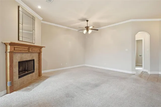 an empty room with a fireplace and fan
