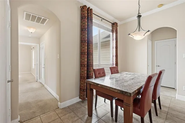 a dining room with a table and chairs