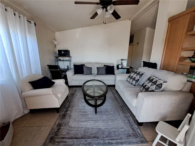 a living room with furniture a rug and a window