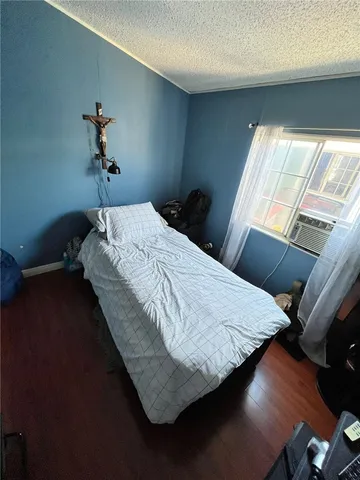 a bed sitting in a bedroom next to a window